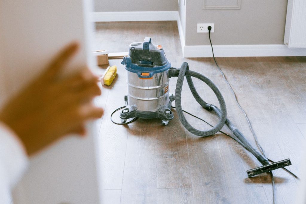Wet and dry vacuum cleaning builders’ dust from a new floor